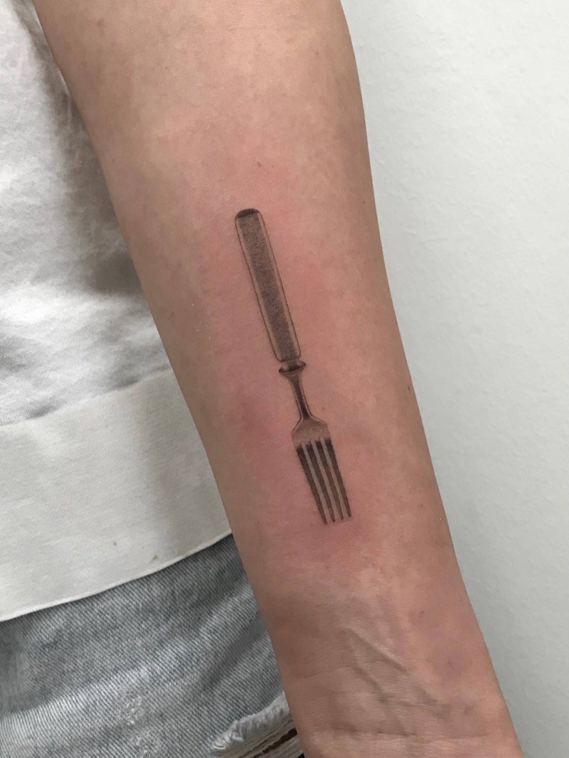 Black and gray realistic fork tattoo on forearm by Irka in Helsinki