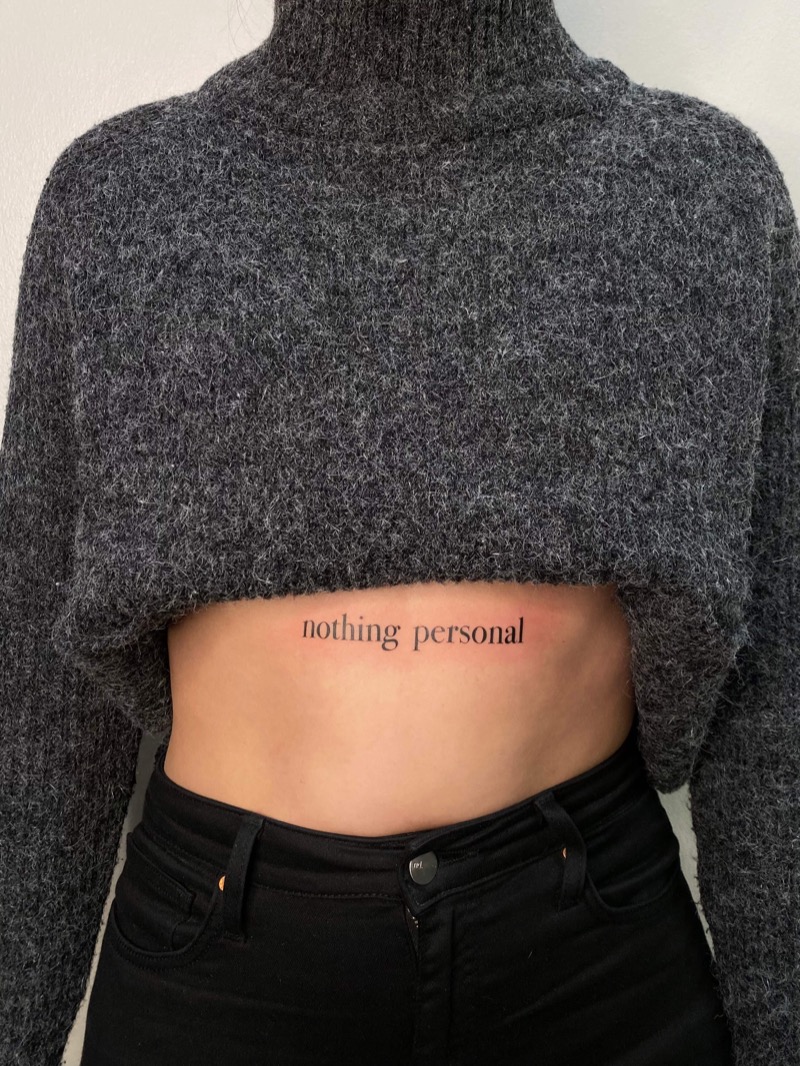 Serif script text tattoo on stomach by Irka in Helsinki