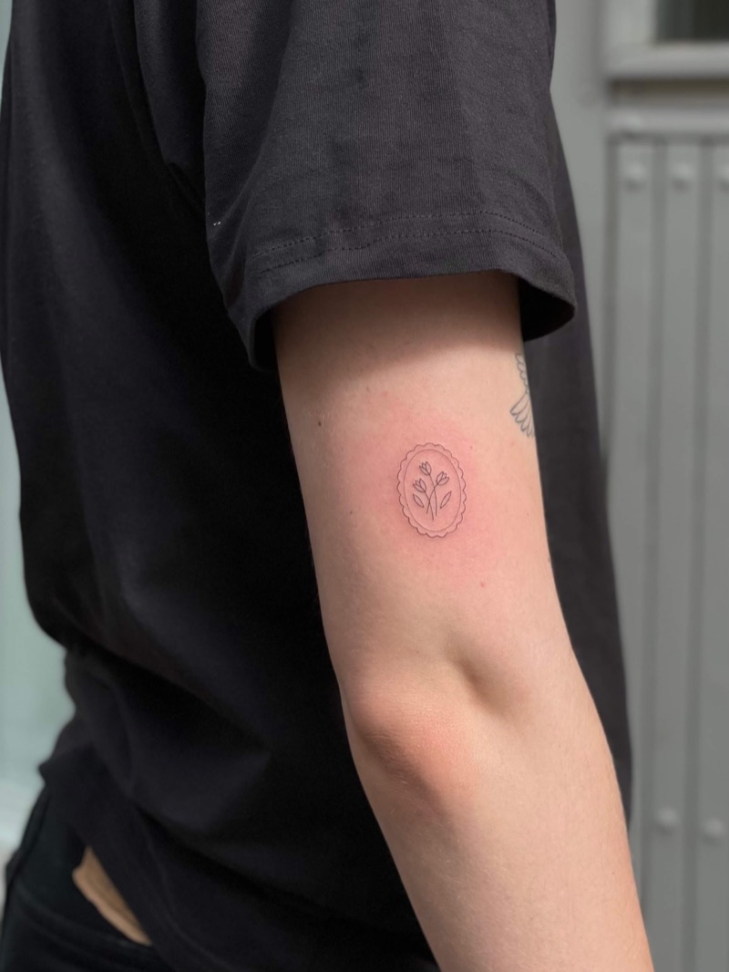 Tiny floral cameo tattoo on inner arm by Irka in Helsinki